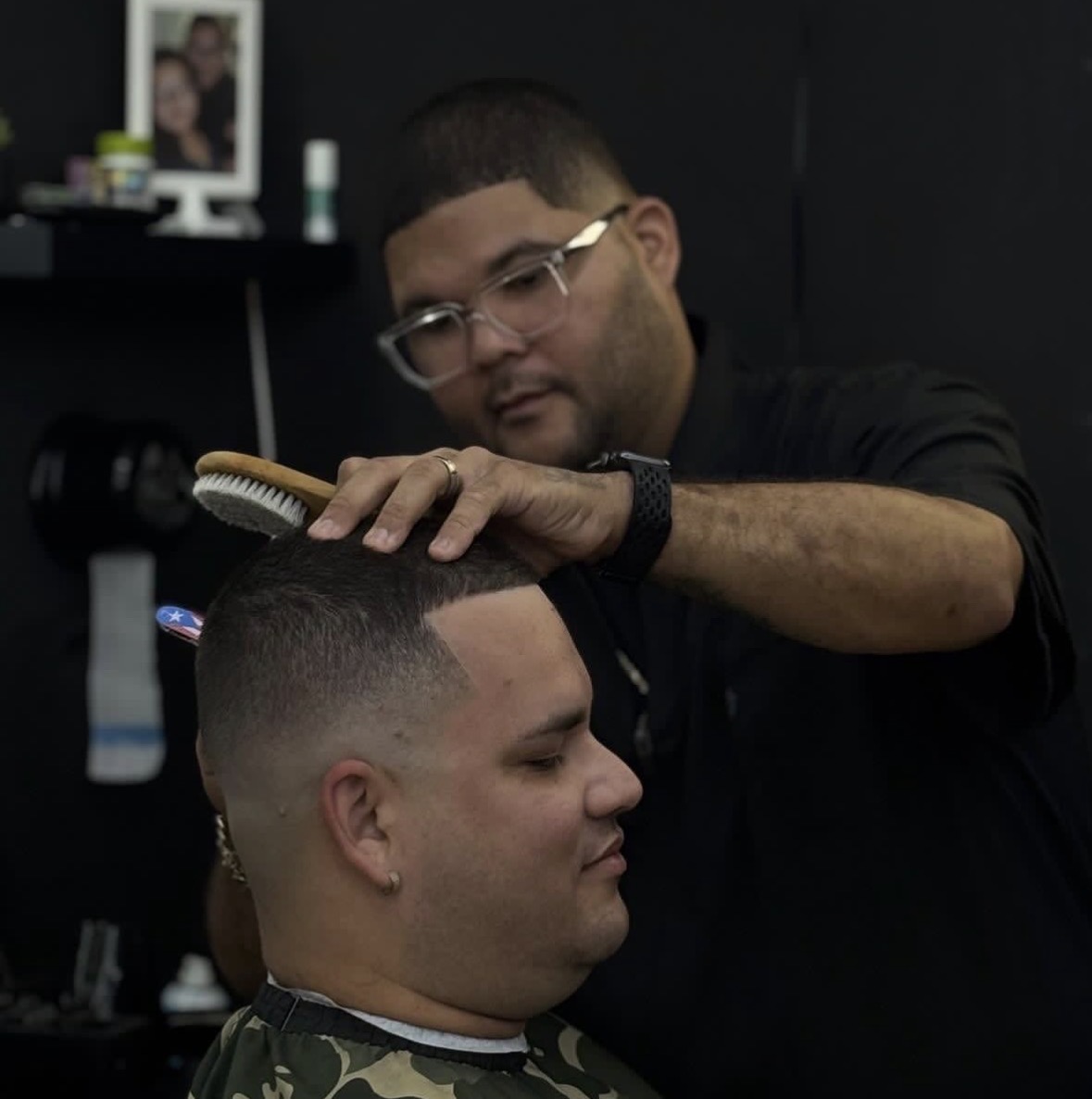 Skilled barber at Shaddai cutting hair