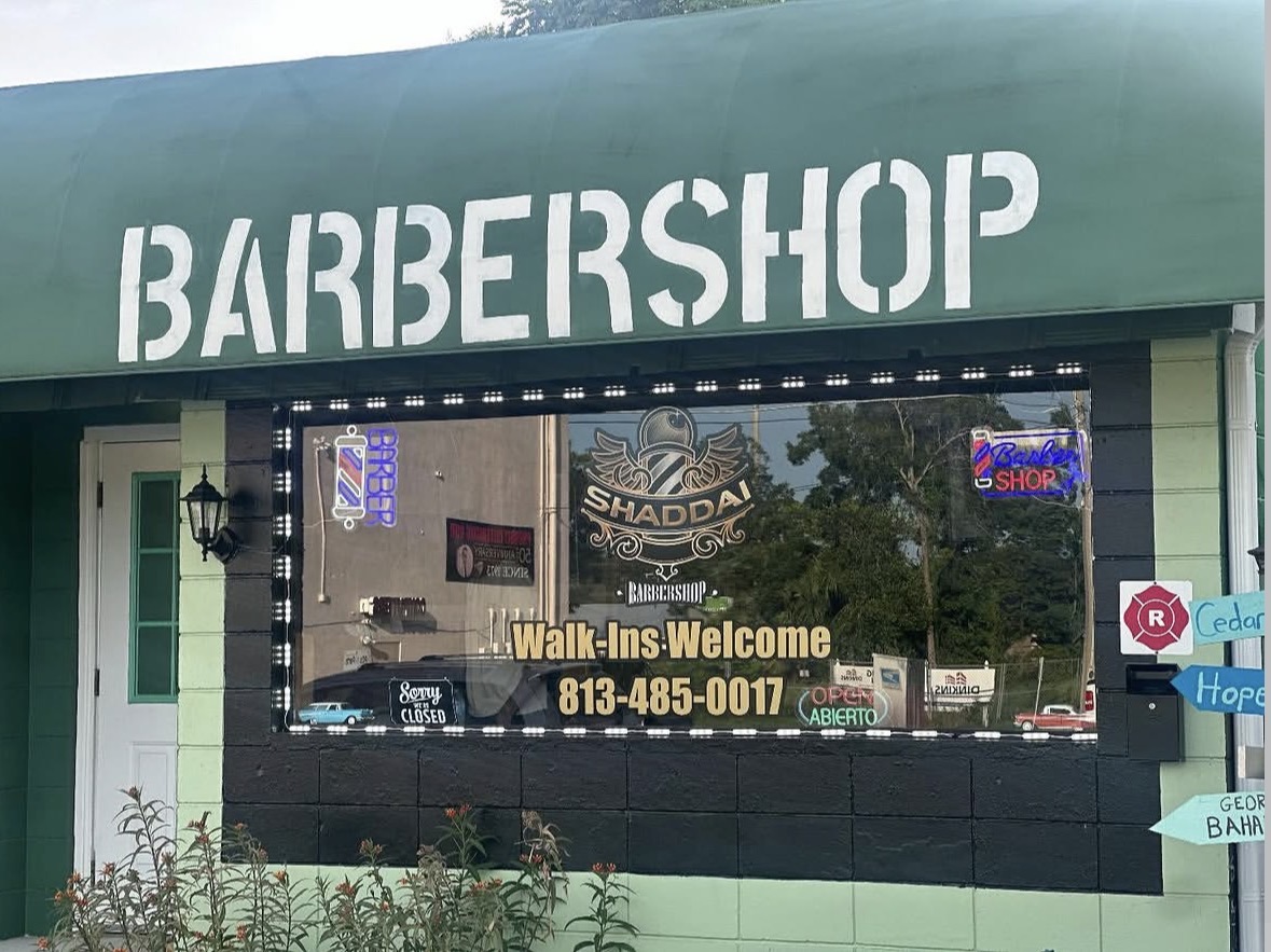 Shaddai Barbershop storefront with green awning